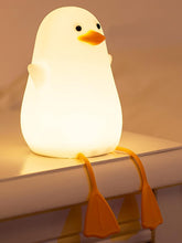 Light-up duck toy on a shelf with a warm glow
